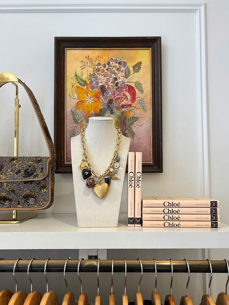 charm necklace on a bookshelf in a retail store